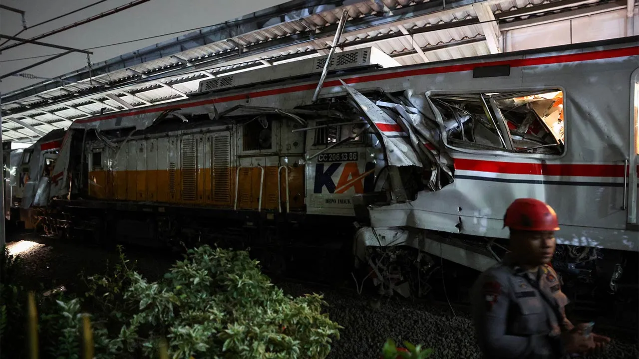 A police officer stands near the damaged train, after two trains collided late on Monday in Bekasi, West Java province, Indonesia, April 28, 2026. REUTERS/Ajeng Dinar Ulfiana