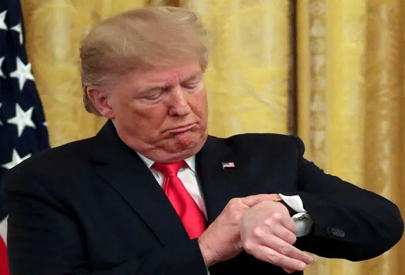 U.S. President Donald Trump checks his watch during an event to celebrate federal judicial confirmations in the East Room of the White House in Washington, D.C., U.S., November 6, 2019. REUTERS/Jonathan Ernst