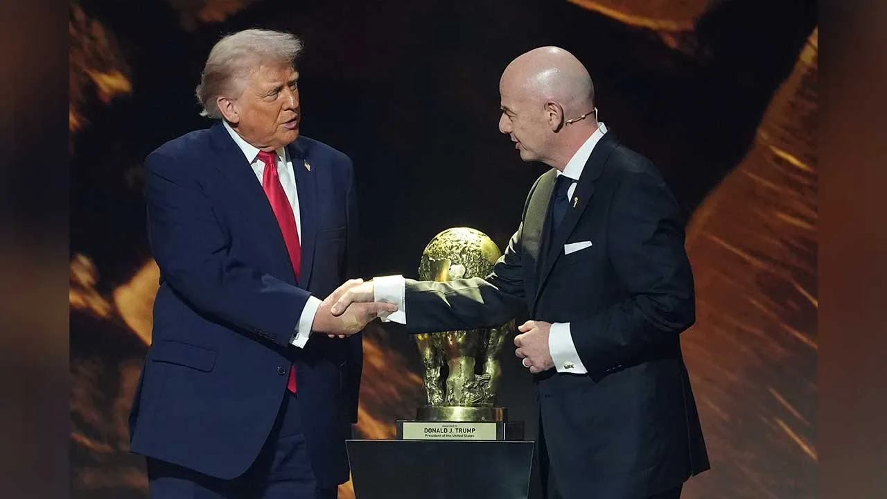 FILE - President Donald Trump shakes hands with FIFA President Gianni Infantino as he presented with the inaugural FIFA Peace Prize during the 2026 FIFA World Cup draw at the Kennedy Center, Dec. 5, 2025, in Washington. (AP Photo/Evan Vucci, File)