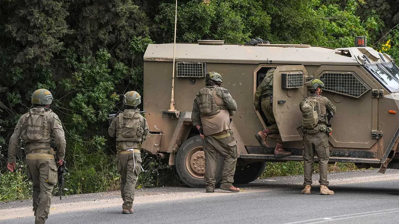 Israeli soldiers go back to their vehicle after they went to shelter during sirens for a drone attack from Lebanon towards Israel at the Israeli side of the Israel-Lebanon border, May 19, 2026 REUTERS/Ayal Margolin ISRAEL OUT. NO COMMERCIAL OR EDITORIAL SALES IN ISRAEL