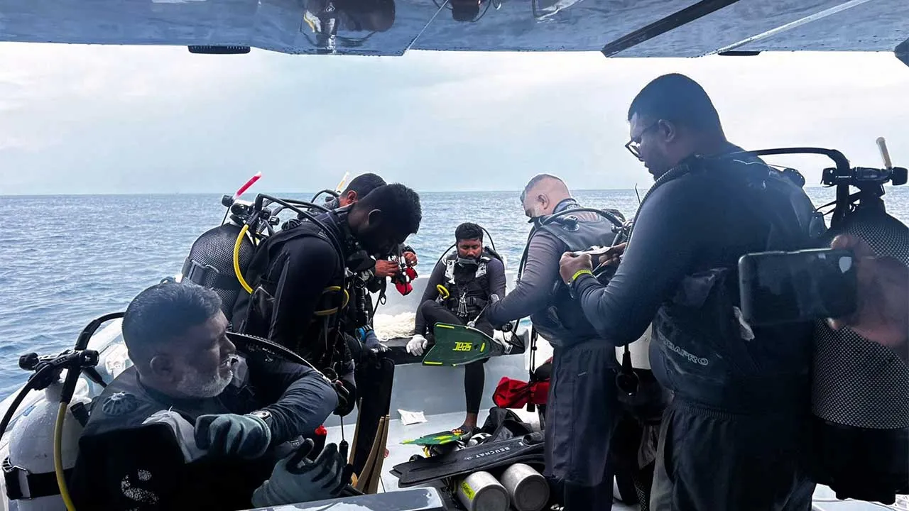 This image released by the Maldives President's Media Division, shows divers preparing to search for the four missing Italian divers near Alimathaa Island, Vaavu Atoll, Maldives, Saturday, May 15, 2026. (Maldives President's Media Division via AP)