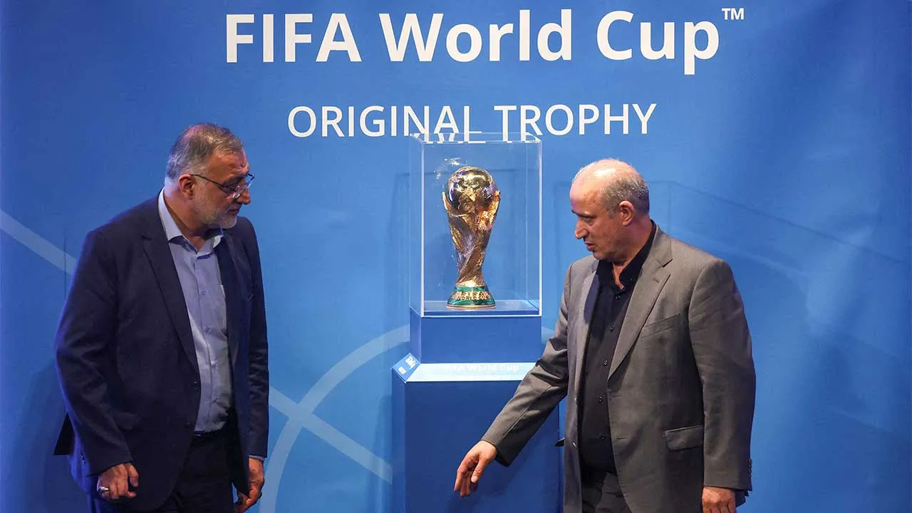 FILE PHOTO: President of Iran Football Federation Mehdi Taj and Mayor of Tehran Alireza Zakani stand next to the FIFA World Cup Trophy during an unveiling ceremony in Tehran, Iran September 1, 2022. Majid Asgaripour/WANA (West Asia News Agency) via REUTERS ATTENTION EDITORS - THIS IMAGE HAS BEEN SUPPLIED BY A THIRD PARTY./File Photo