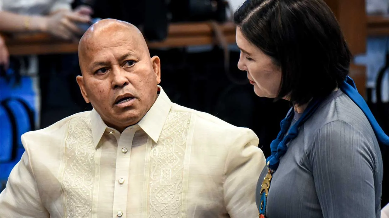 Philippine Senator Ronald dela Rosa, left, talks with Senator Pia Cayetano as he arrives at the Philippine Senate in Pasay, Philippines on Monday, May 11, 2026. (AP Photo/Angie de Silva)