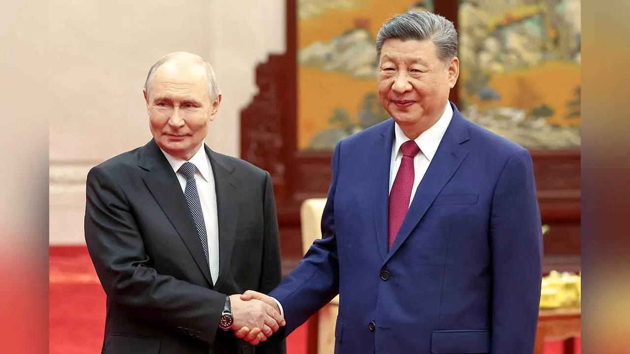 Russian President Vladimir Putin and Chinese President Xi Jinping shake hands as they pose for photos before a tea ceremony following their meeting at the Great Hall of the People in Beijing, China May 20, 2026. Sputnik/Alexander Kazakov/Pool via REUTERS ATTENTION EDITORS - THIS IMAGE WAS PROVIDED BY A THIRD PARTY.