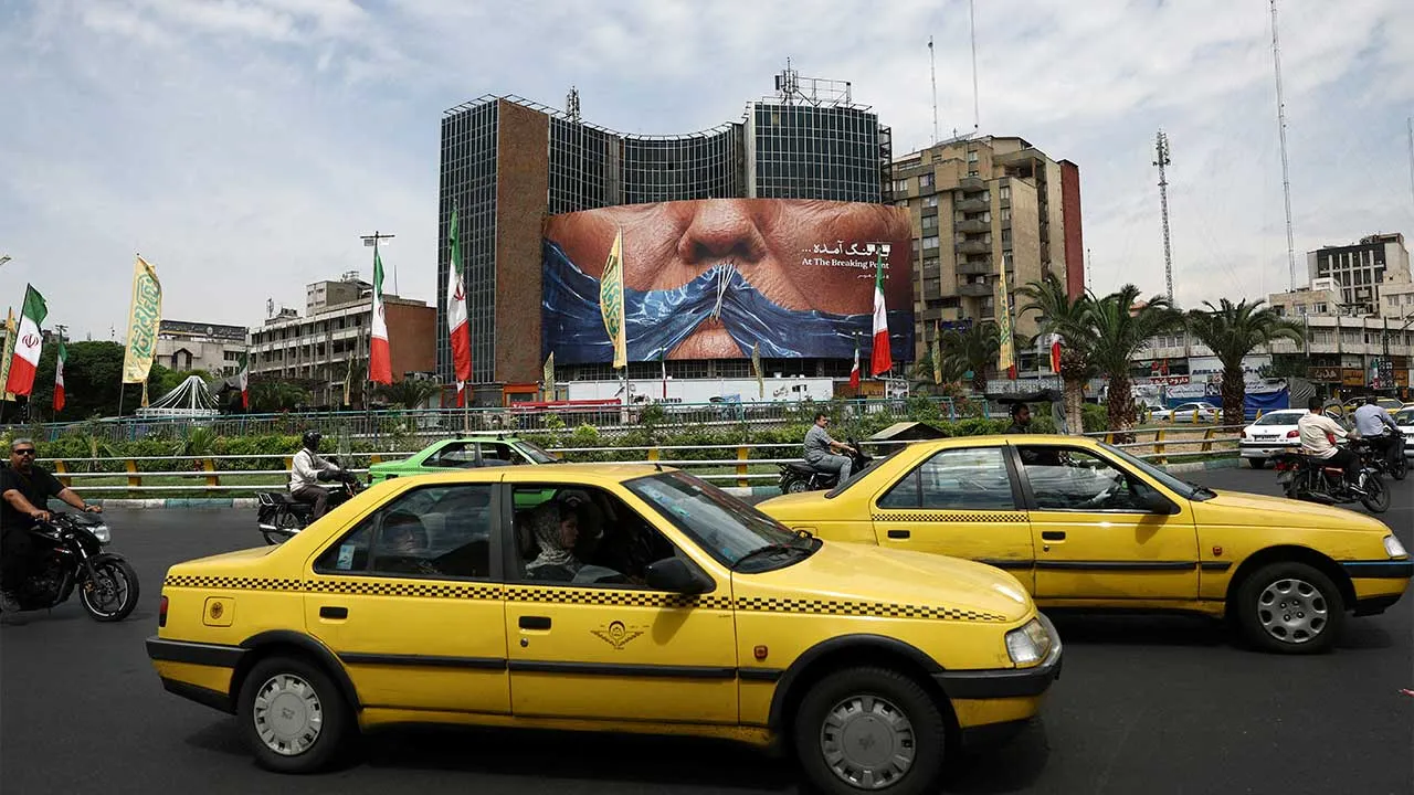 People drive past an anti-U.S. billboard depicting U.S. President Donald Trump and the Strait of Hormuz, in Tehran, Iran, May 2, 2026. Majid Asgaripour/WANA (West Asia News Agency) via REUTERS ATTENTION EDITORS - THIS PICTURE WAS PROVIDED BY A THIRD PARTY