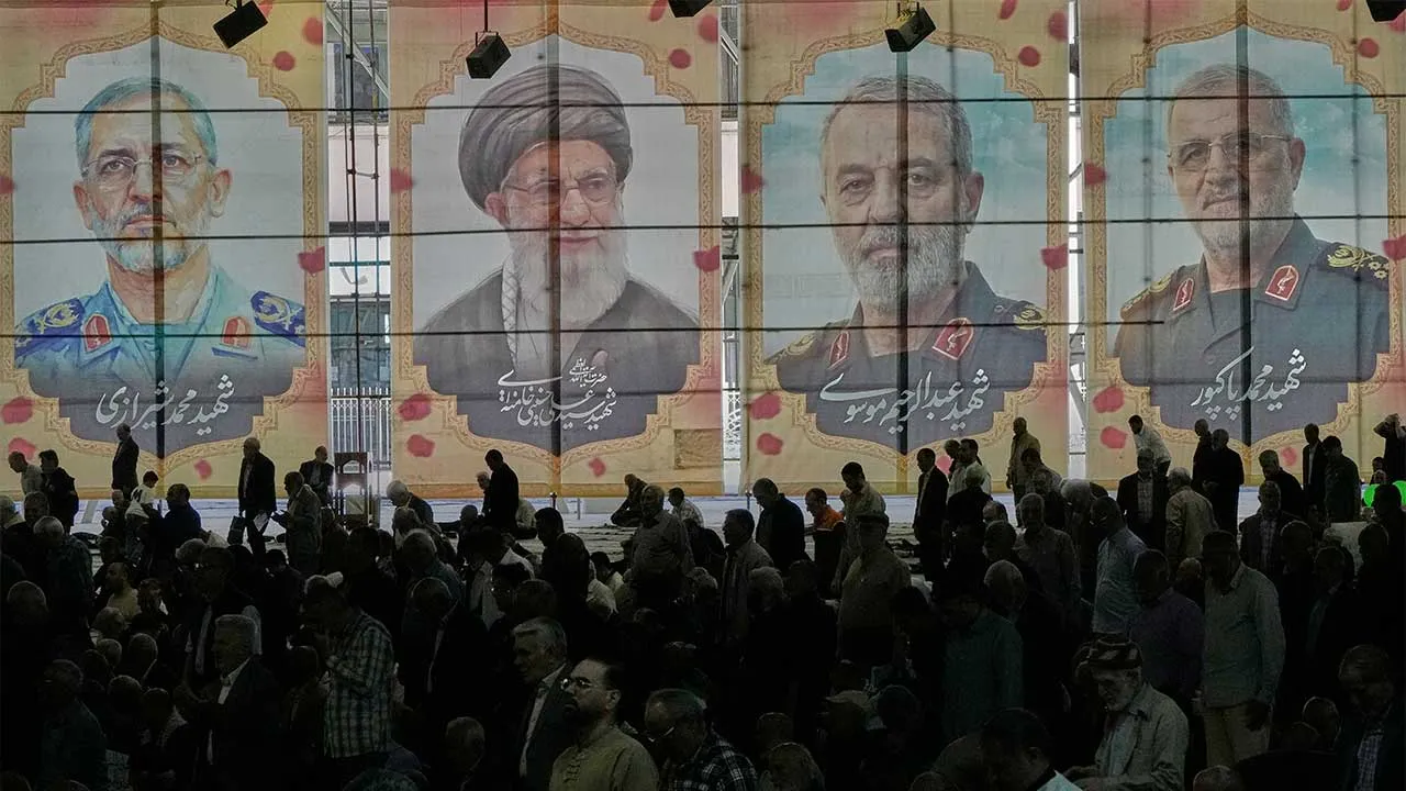 Iranian worshippers perform their Friday prayers under the portraits of the late Iranian Supreme Leader Ayatollah Ali Khamenei, second left, and top military officials who were killed during the U.S.-Israel campaign, at the Tehran University campus, in Tehran, Iran, Friday, April 24, 2026. (AP Photo/Vahid Salemi)