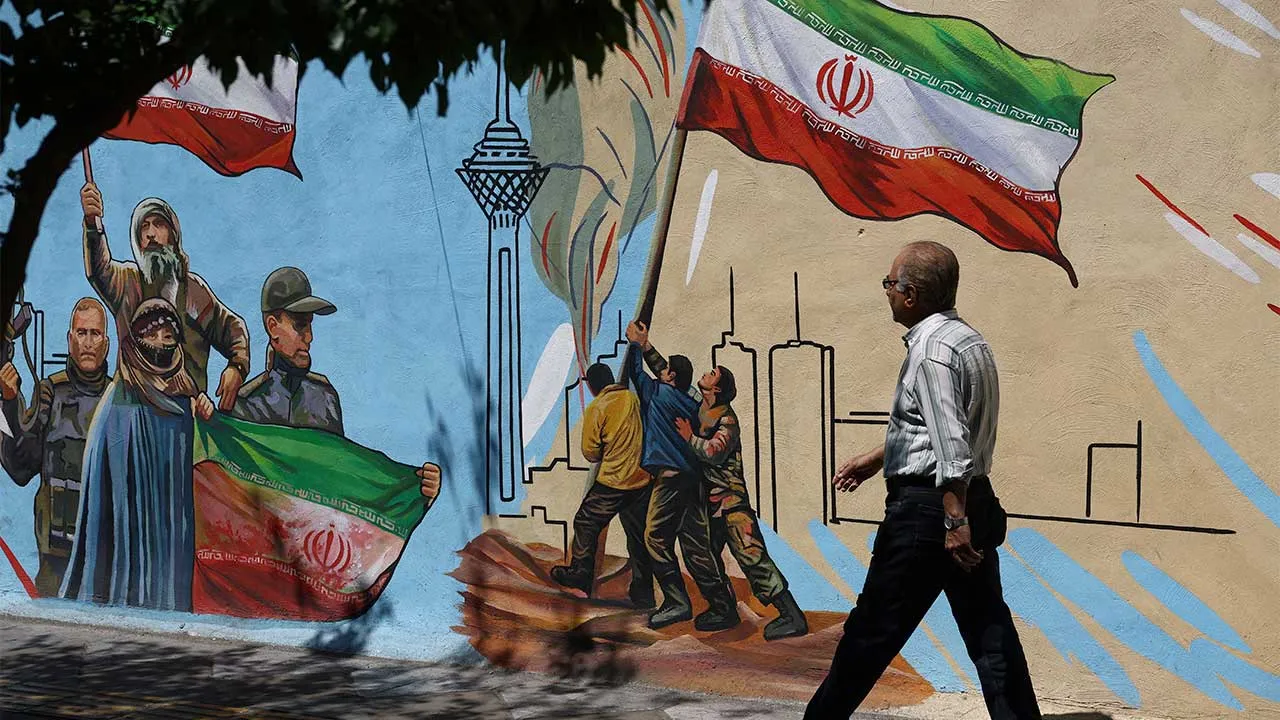 An Iranian man walks next to a mural on a street in Tehran, Iran, May 11, 2026. Majid Asgaripour/WANA (West Asia News Agency) via REUTERS ATTENTION EDITORS - THIS PICTURE WAS PROVIDED BY A THIRD PARTY