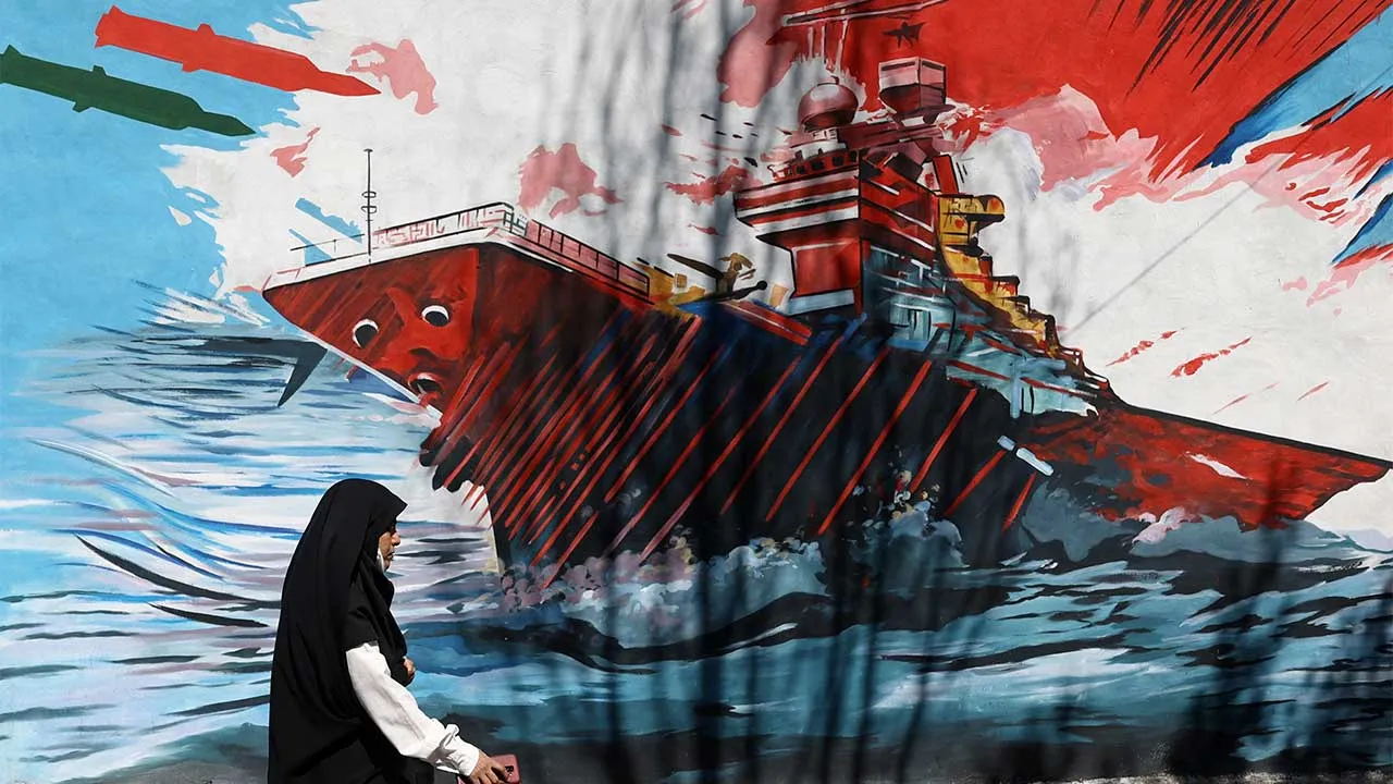 A woman walks next to a mural on a street in Tehran, Iran, May 18, 2026. Majid Asgaripour/WANA (West Asia News Agency) via REUTERS ATTENTION EDITORS - THIS PICTURE WAS PROVIDED BY A THIRD PARTY