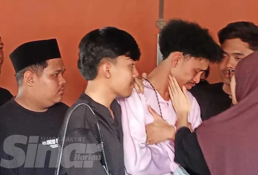 Mohd Izat (dua kanan) ditenangkan ahli keluarga ketika berada di Unit Perubatan Forensik Hospital Kota Tinggi.