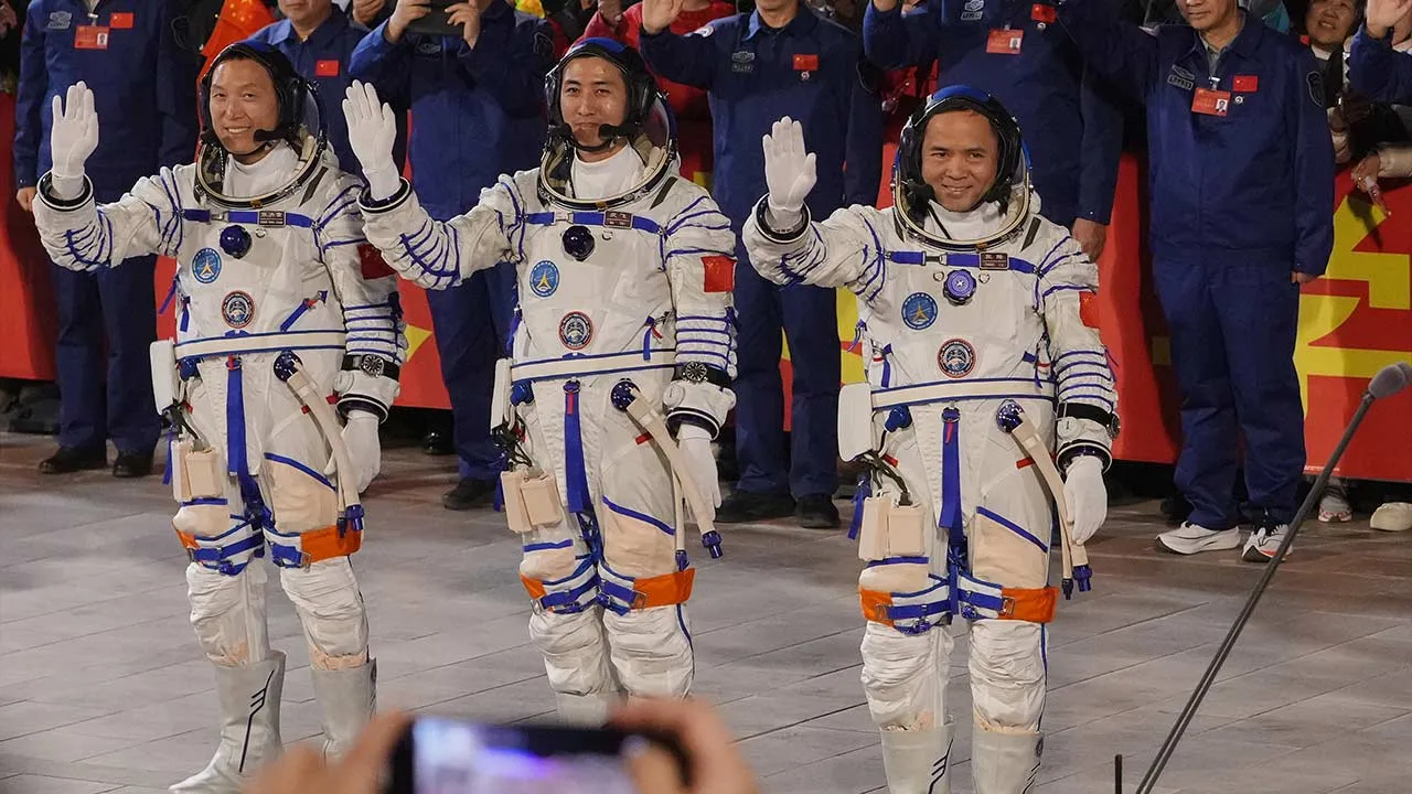 FILE - Chinese astronaut for the Shenzhou 21 mission, from left, Zhang Hongzhang, Wu Fei and Zhang Lu wave as they attend a see-off ceremony for their manned space mission at the Jiuquan Satellite Launch Center in northwestern China, Friday, Oct. 31, 2025. (AP Photo/Andy Wong, File)