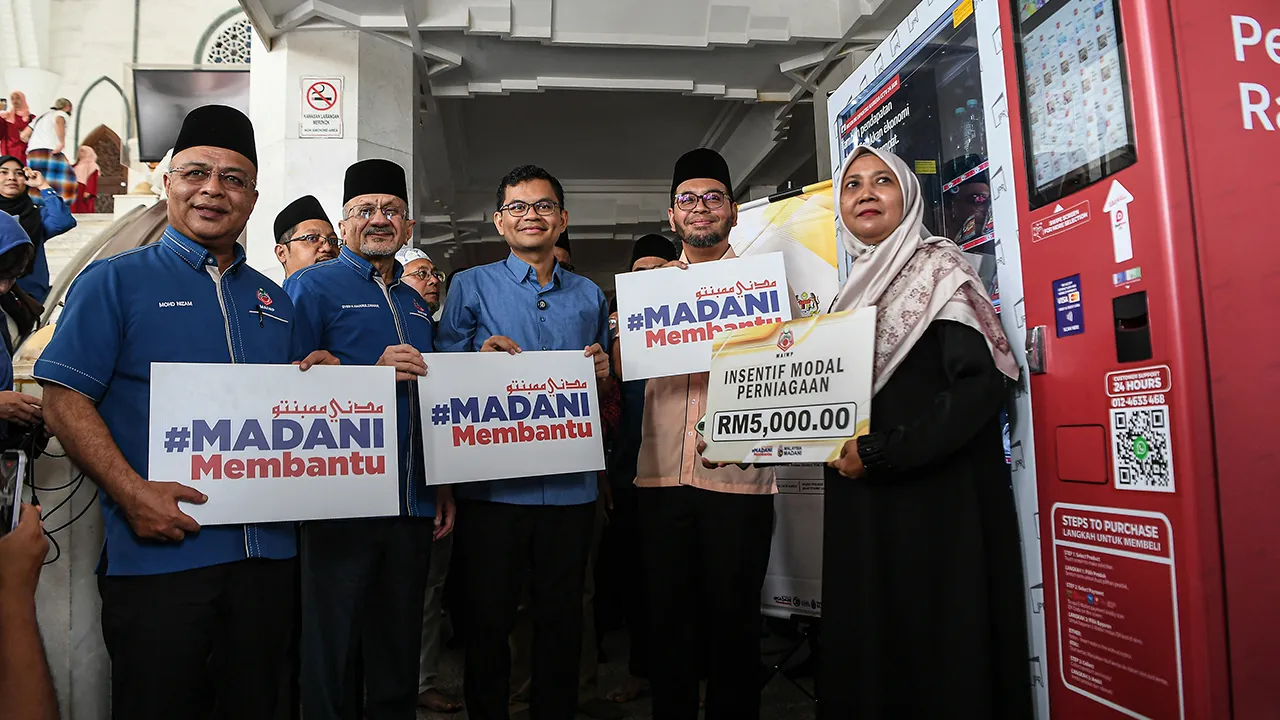KUALA LUMPUR, 16 Mei -- Menteri di Jabatan Perdana Menteri (Hal Ehwal Agama) Dr Zulkifli Hasan (dua, kanan) bersama Menteri Ekonomi Akmal Nasrullah Mohd Nasir (tengah) menyerahkan replika cek kepada penerima Inisiatif Modal Perniagaan iaitu Yazrina Md Yamin (kanan) pada Majlis Perasmian Kerjasama Strategik Kementerian Ekonomi dan Majlis Agama Islam Wilayah Persekutuan di bawah Program Inisiatif Pendapatan Rakyat - Inisiatif Usahawan Makanan (IPR-INSAN) di Masjid Wilayah Persekutuan hari ini.  -- fotoBERNAMA