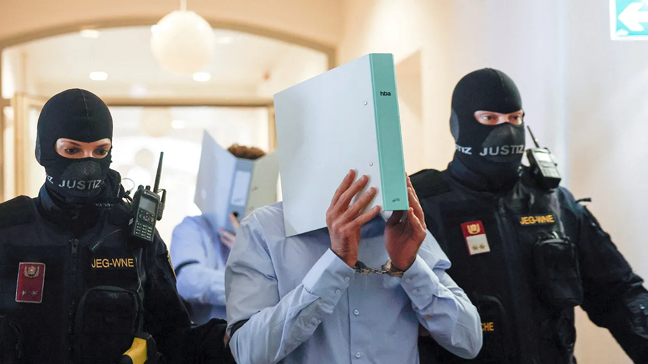 Austrian defendant identified as Beran A, suspected of planning an attack on U.S. singer Taylor Swift's Vienna concert in 2024, is escorted by security personnel in a courtroom for his trial in Wiener Neustadt, Austria, May 28, 2026. REUTERS/Lisa Leutner TPX IMAGES OF THE DAY