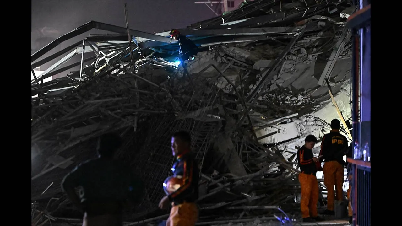 Rescue workers search for survivors among the debris after a nine-story building under construction collapsed in Balibago, Angeles City, Pampanga, Philippines, May 24, 2026. REUTERS/Noel Celis