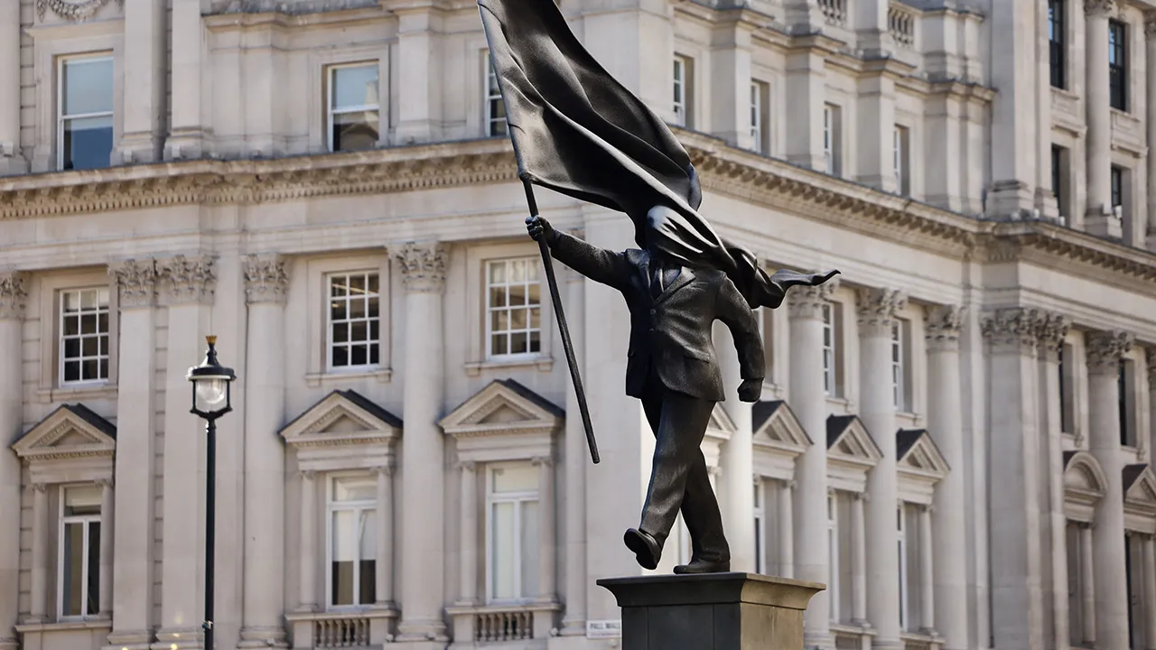 A statue depicting a person stepping off the plinth while carrying a flag covering their face, by British street artist Banksy, stands in London, Britain, April 30, 2026. REUTERS/Jack Taylor