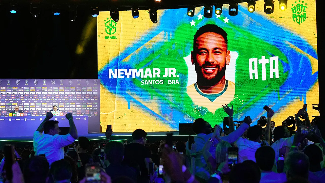 A screen displays an image of Neymar after coach Carlo Ancelotti, left, included him in Brazil's squad for the 2026 FIFA World Cup in Rio de Janeiro, Monday, May 18, 2026. (AP Photo/Silvia Izquierdo)