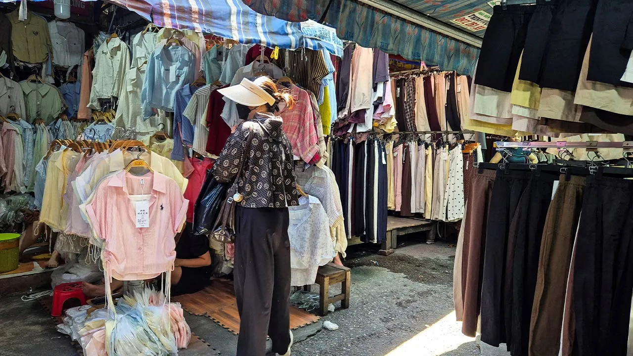 A woman shops at Ninh Hiep market, classified by the U.S. Trade Representative among "notorious markets" for counterfeiting, despite government crackdowns and the threat of U.S. tariffs over the issue, on the outskirts of Hanoi, Vietnam, May 25, 2026. Picture taken with a mobile phone. REUTERS/Khanh Vu
