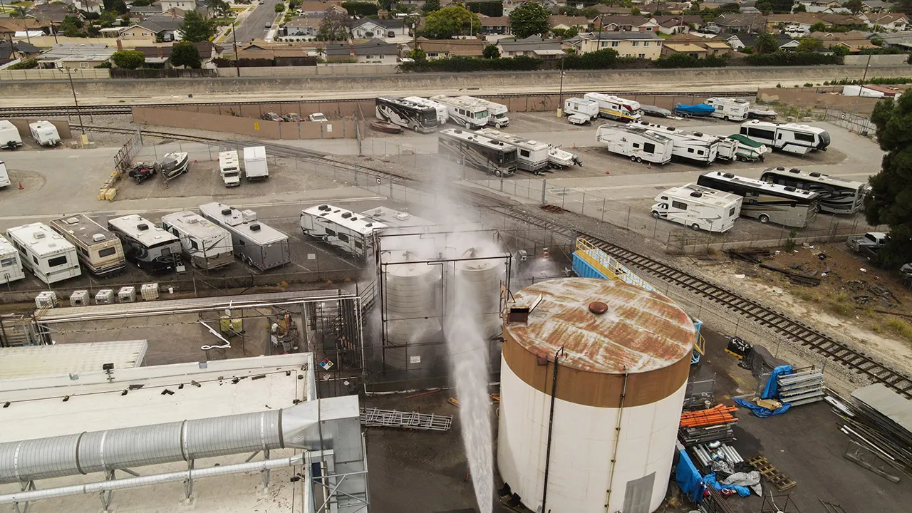 A drone view shows water being sprayed during a chemical incident involving a leaking tank of methyl methacrylate, a flammable liquid used in the aerospace industry, forcing an evacuation in the surrounding area, in Garden Grove, California, U.S., May 23, 2026. REUTERS/David Swanson