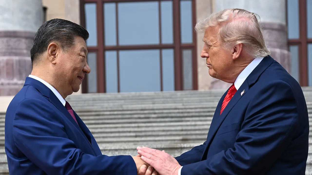 Chinese President Xi Jinping, left, shakes hands with U.S. President Donald Trump at the Great Hall of the People in Beijing, Thursday, May 14, 2026. (Kenny Holston/Pool Photo via AP)