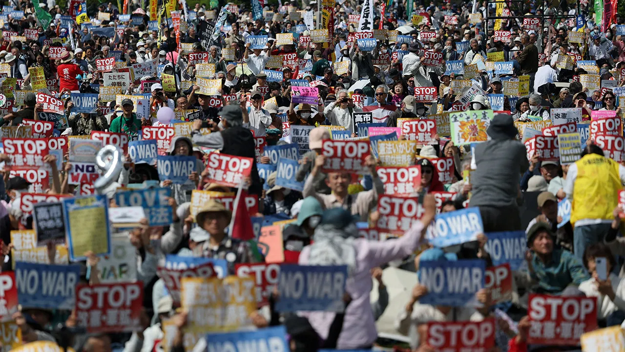 Participants and protesters hold posters opposing Japan’s Prime Minister Sanae Takaichi's administration and her policies on constitutional revision and military expansion during a Constitution Memorial Day rally in Tokyo, Japan, May 3, 2026. REUTERS/Issei Kato