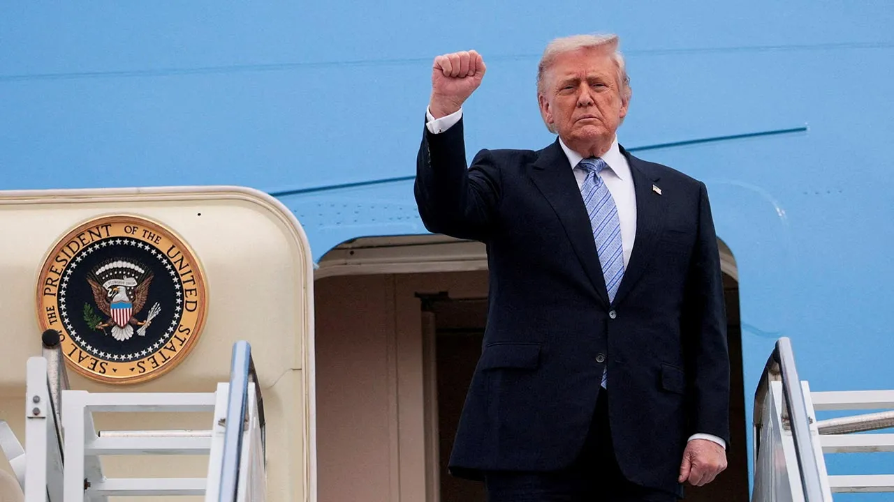 FILE PHOTO: U.S. President Donald Trump gestures as he departs Beijing Capital International Airport aboard Air Force One, in Beijing, China, May 15, 2026. REUTERS/Evan Vucci REFILE - QUALITY REPEAT/File Photo
