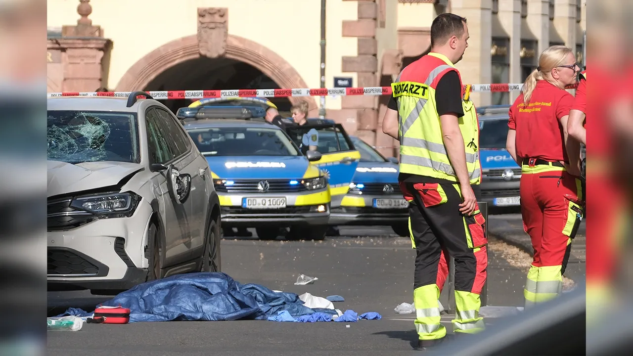 Rescue workers stand next to a damaged car that has crashed into several people in Leipzig, Germany, Monday, May 4, 2026. (Sebastian Willnow/dpa via AP)