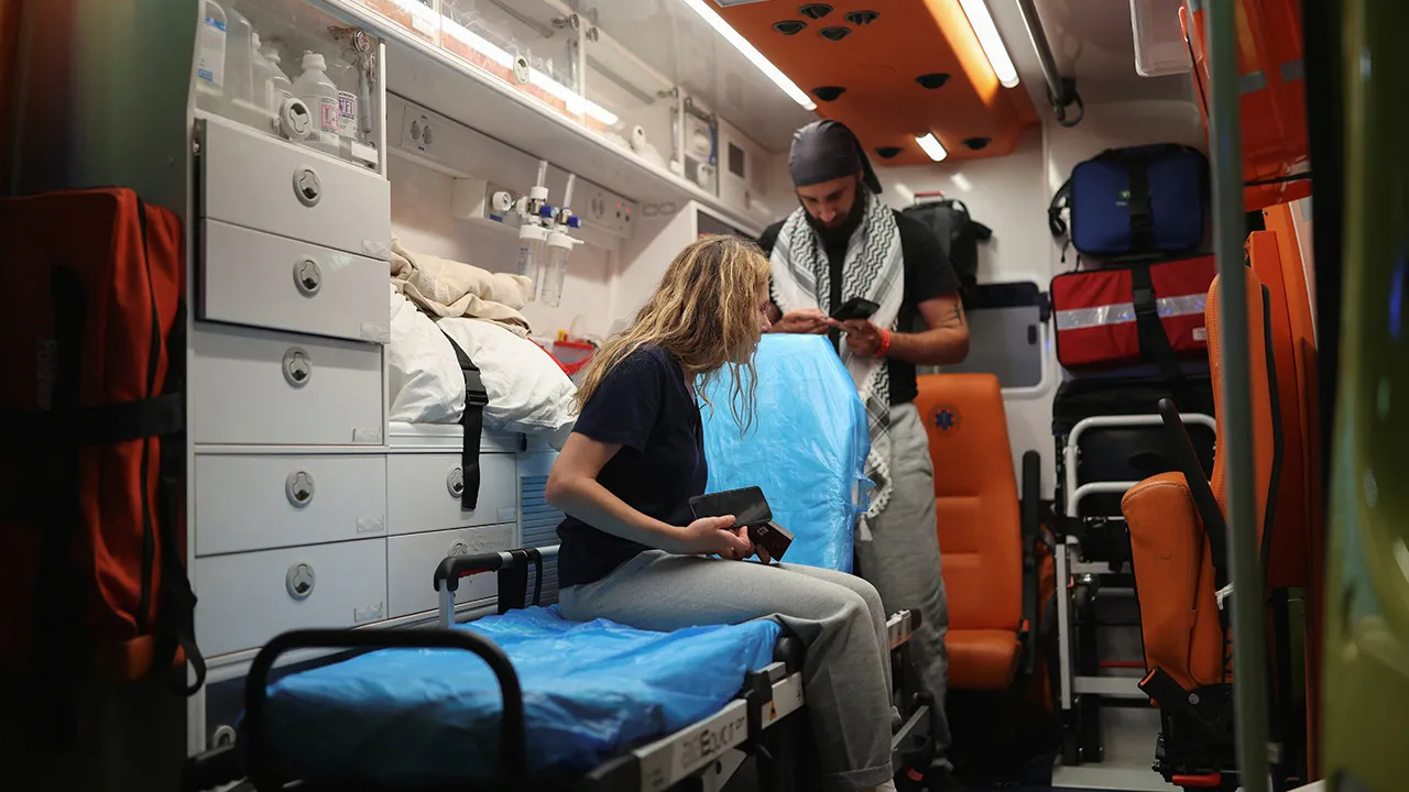 A Greek activist from the Gaza-bound Global Sumud Flotilla, detained by Israeli forces after their vessels were intercepted in international waters in the Mediterranean, sits on a stretcher inside an ambulance upon arrival at the Athens Eleftherios Venizelos International airport in Spata, Greece, May 22, 2026. REUTERS/Stelios Misinas