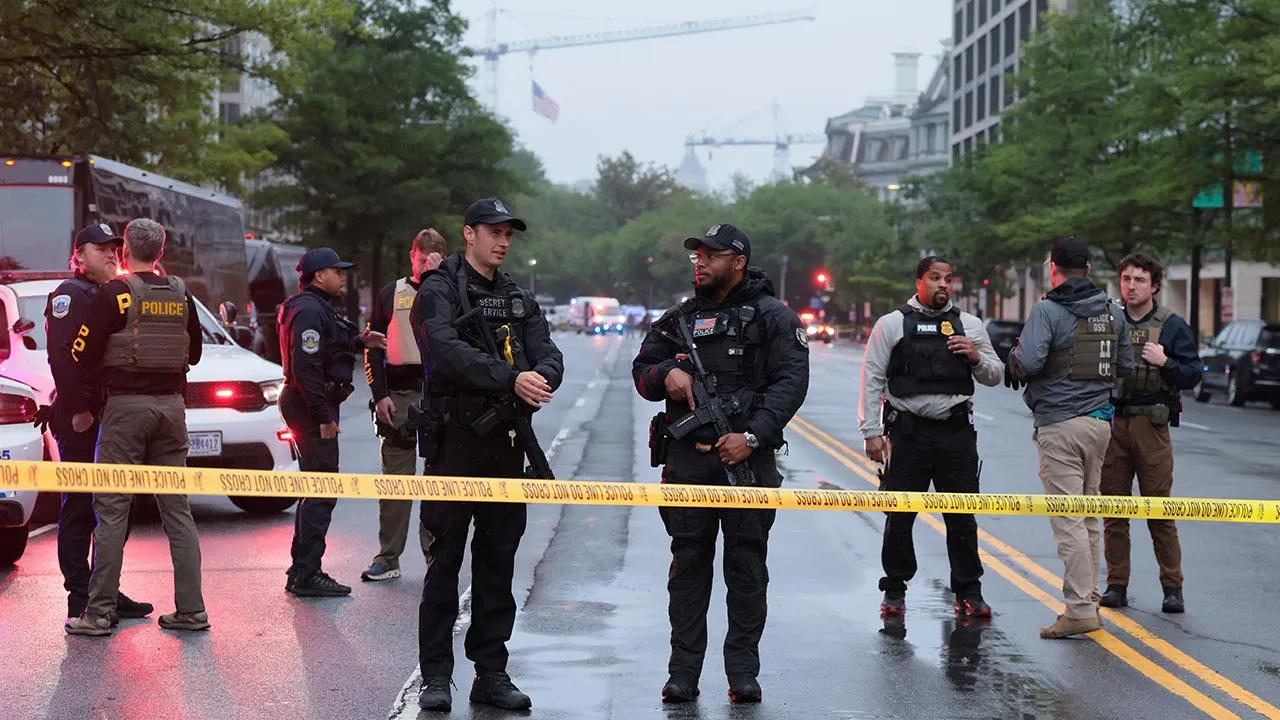 Law enforcement agents stand behind yellow tape near the White House, after gunshots were heard nearby, in Washington, D.C., U.S., May 23, 2026. REUTERS/Kylie Cooper
