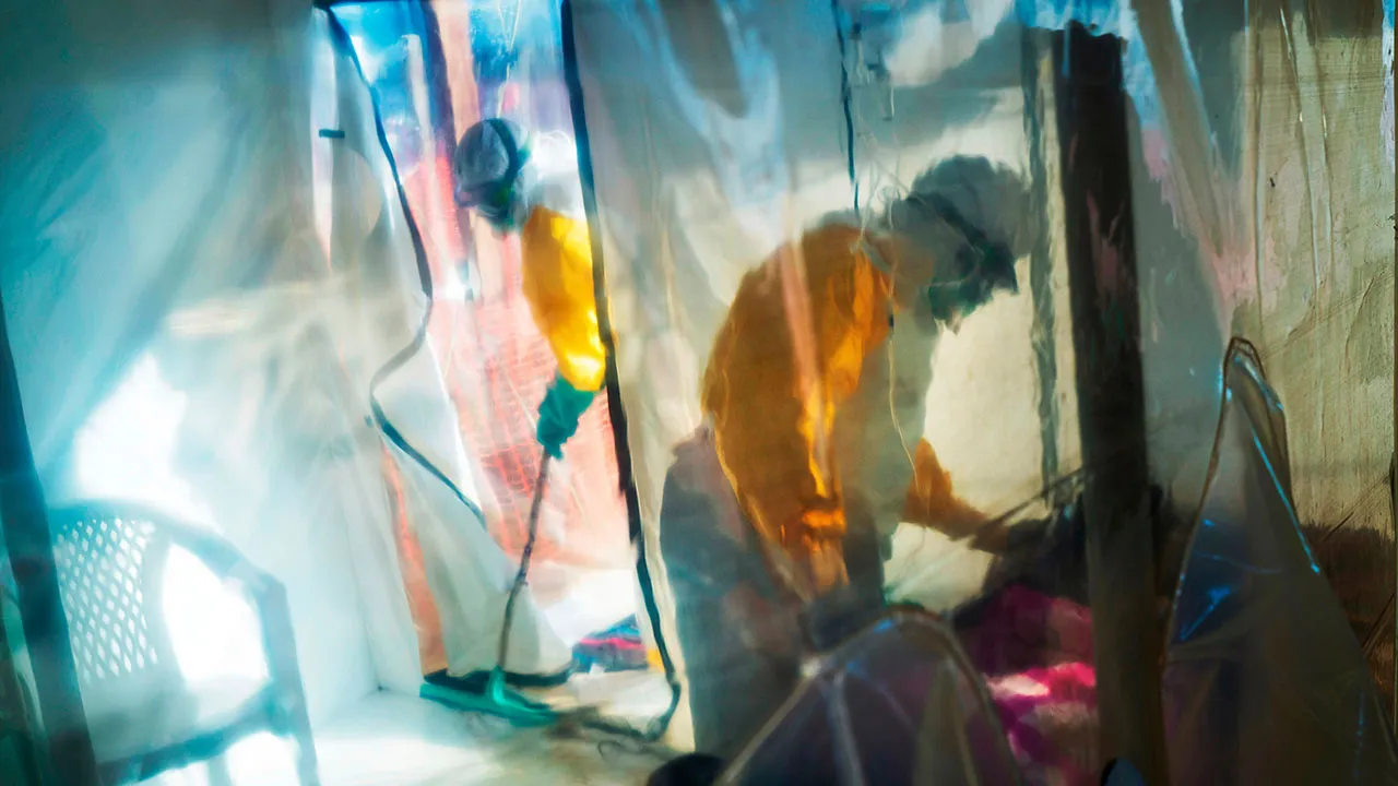 Health workers wearing protective suits tend to an Ebola victim kept in an isolation tent in Beni, Congo, July 13, 2019. (AP Photo/Jerome Delay