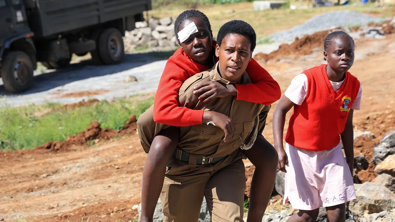 An injured student is evacuated following an early morning fire outbreak at Utumishi Girls School in the Gilgil area, central Kenya, Thursday, May 28, 2026. (AP Photo/Andrew Kasuku)