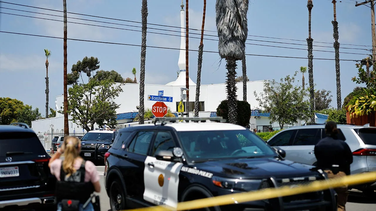 Emergency workers respond at the scene of a reported active shooter situation at the Islamic Center, with yellow tape to cordon the area in the foreground, in San Diego, California, U.S., May 18, 2026. REUTERS/Mike Blake