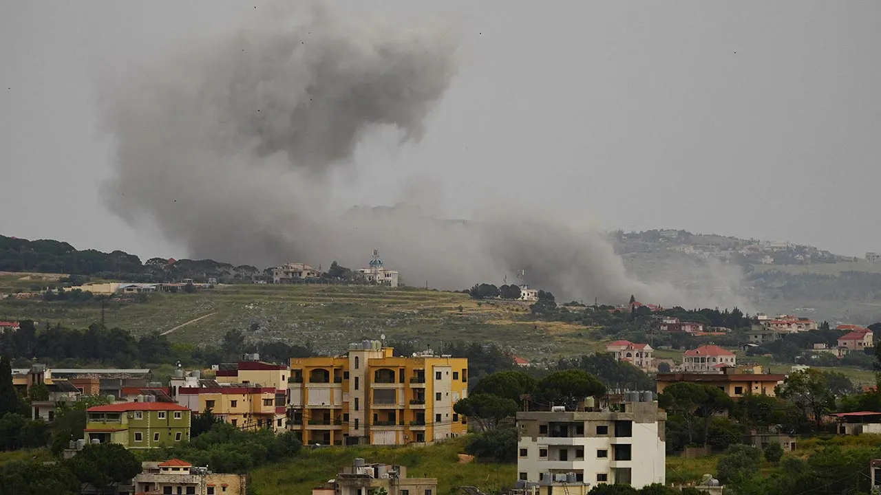 Smoke billows from Kfar Tebnit, following an Israeli strike, as seen from Nabatieh, southern Lebanon, May 18, 2026. REUTERS/Stringer