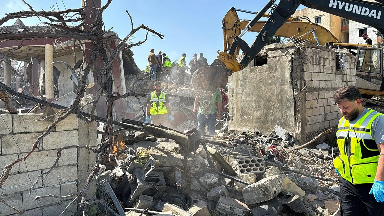 Emergency responders assisted by other people and heavy machinery inspect the site of an Israeli strike in Saksakiyeh, Lebanon, May 9, 2026. Picture taken with a mobile phone. REUTERS/Stringer