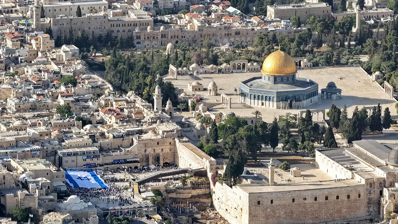 A drone view of a large Israeli flag at the Western Wall Plaza, Judaism's holiest prayer site, next to the Al-Aqsa compound, known to Jews as the Temple Mount, during the annual Jerusalem Day, in Jerusalem's Old City, May 14, 2026. REUTERS/Ilan Rosenberg