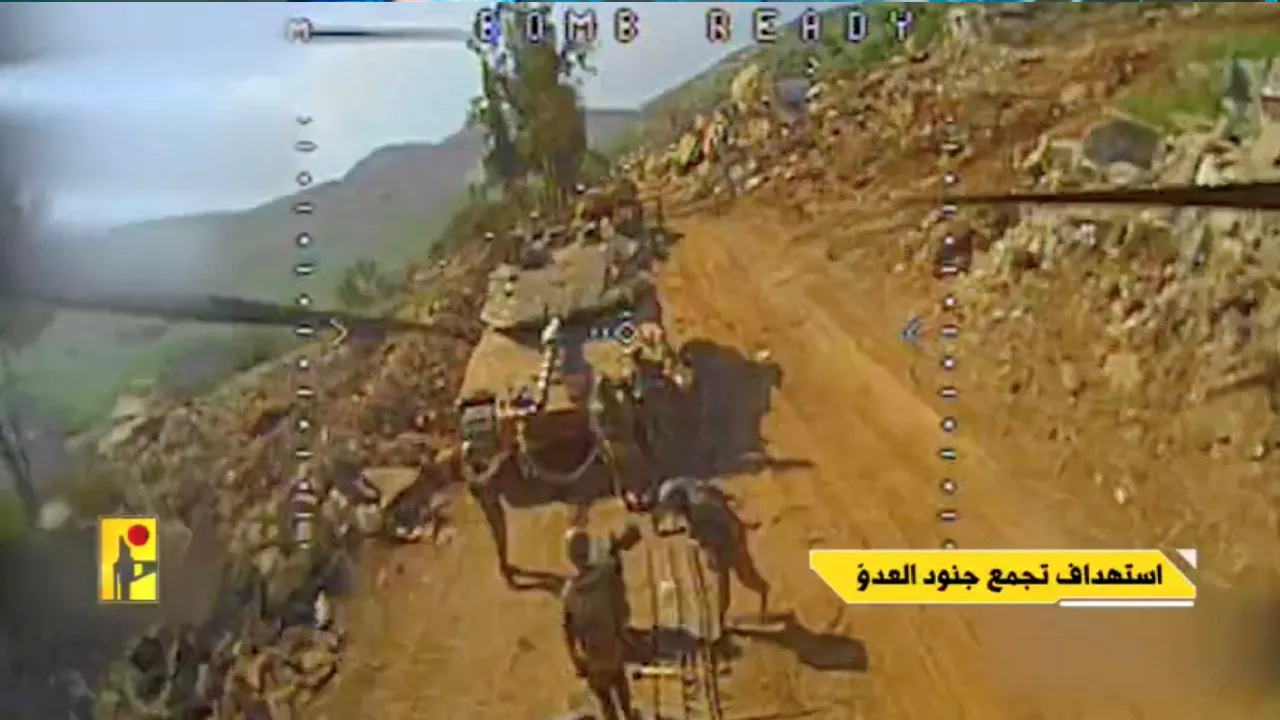 A screengrab taken from a video released by Hezbollah says to show an Israeli tank and soldiers gathered next to it moments before being hit by an FPV drone attack, in Taybeh, Lebanon, with the date of the video given as April 26, 2026. HEZBOLLAH MILITARY MEDIA/Handout via REUTERS