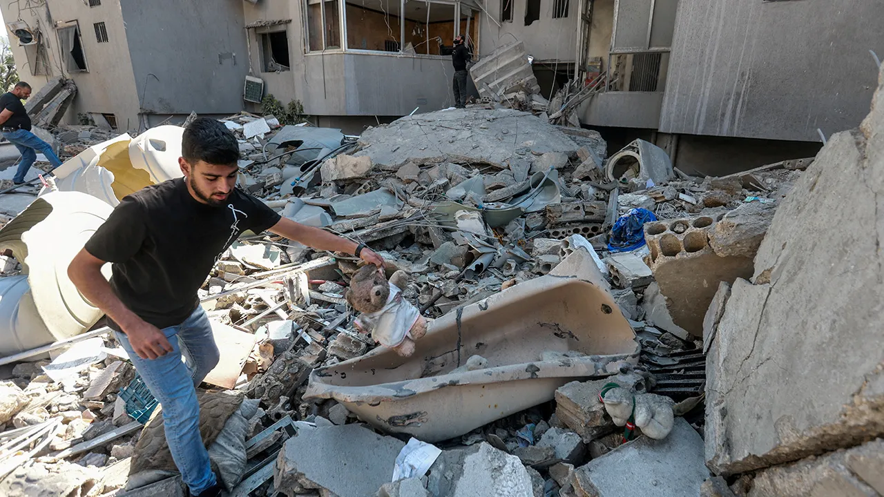 A man holds a stuffed toy at the site of an overnight Israeli strike in the southern city of Tyre, Lebanon, May 23, 2026. REUTERS/Aziz Taher TPX IMAGES OF THE DAY