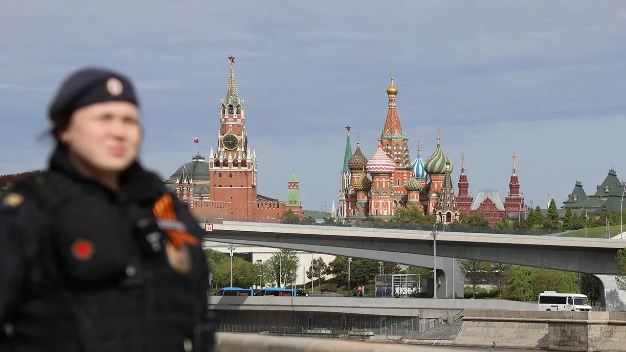 A Russian law enforcement officer stands guard on an embankment of the Moskva River near the Kremlin and St. Basil's Cathedral before a flypast and a military parade on Victory Day, marking the 81st anniversary of the victory over Nazi Germany in World War Two, in central Moscow, Russia, May 9, 2026. REUTERS/Marina Lystseva