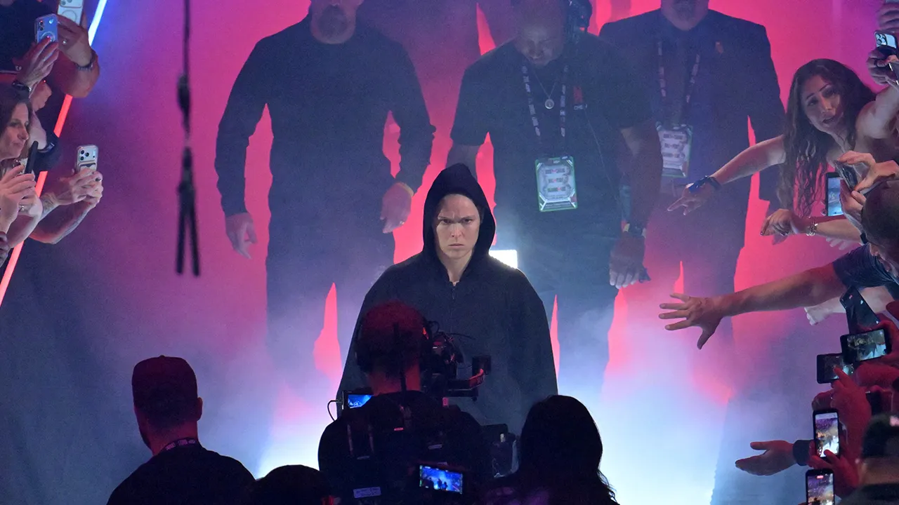 May 16, 2026; Los Angeles, California, USA; Ronda Rousey (blue gloves) is introduced before fighting Gina Carano (red gloves) in a women's featherweight bout at Intuit Dome. Mandatory Credit: Jayne Kamin-Oncea-Imagn Images