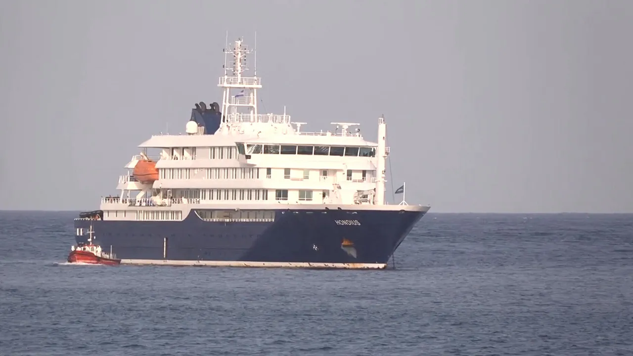 A boat beside cruise ship MV Hondius anchored off Cape Verde port, on the day sick passengers were evacuated by boat from the cruise ship, in Praia Port, Cape Verde, in this screengrab obtained from a video, May 5, 2026. REUTERS TV via REUTERS