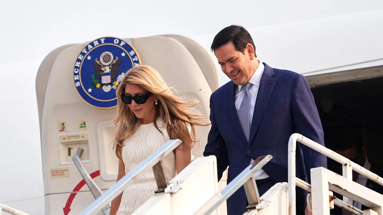 U.S. Secretary of State Marco Rubio disembarks his plane with his wife Jeanette at Netaji Subhash Chandra Bose International Airport in Kolkata, India, Saturday, May 23, 2026. Julia Demaree Nikhinson/Pool via REUTERS
