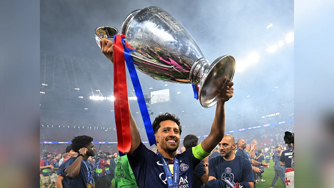 Soccer Football - UEFA Champions League - Final - Paris St Germain v Arsenal - Puskas Arena, Budapest, Hungary - May 30, 2026 Paris St Germain's Marquinhos celebrates with the trophy after winning the UEFA Champions League REUTERS/Angelika Warmuth
