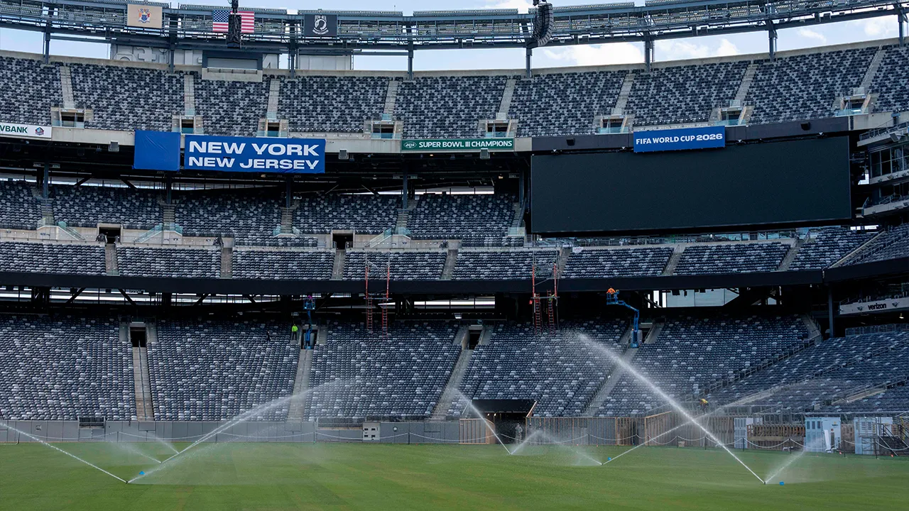 Sprinkler water grass during the pitch installation for FIFA World Cup 2026 at NYNJ Stadium, Thursday, May 7, 2026, in East Rutherford, N.J. (AP Photo/Yuki Iwamura)