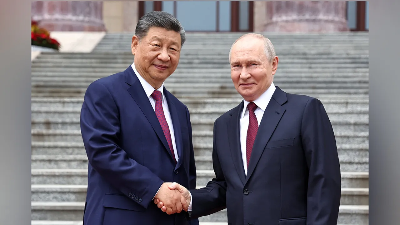 Russian President Vladimir Putin shakes hands with Chinese President Xi Jinping during a welcoming ceremony at the Great Hall of the People in Beijing, China May 20, 2026. Sputnik/Alexander Kazakov/Pool via REUTERS