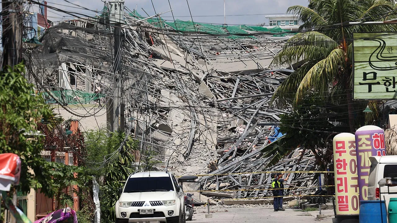Caution tape marks the area around a collapsed building in Angeles city in Pampanga province, north of Manila, Philippines, Sunday May 24, 2026. (AP Photo)