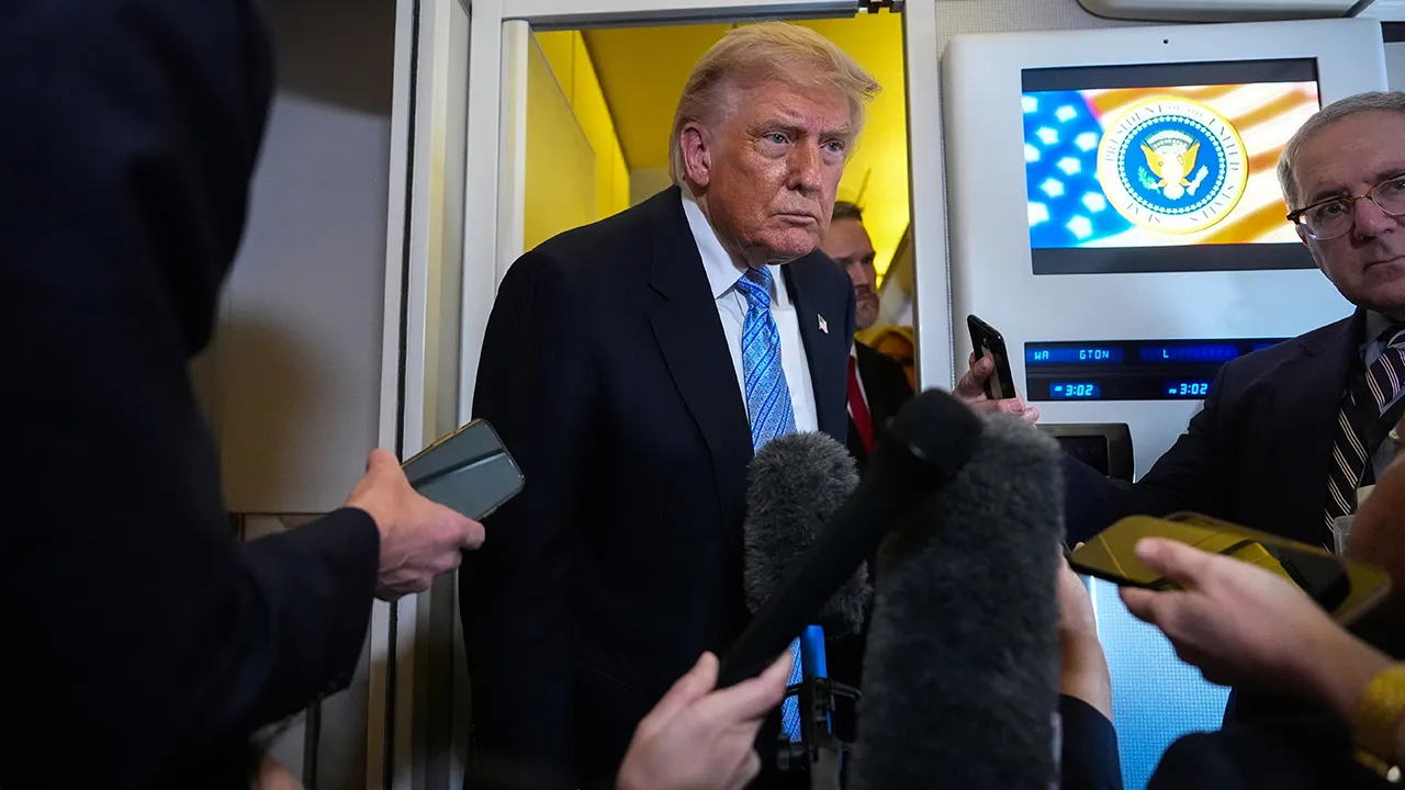 President Donald Trump speaks to reporters aboard Air Force One, Friday, May 15, 2026, as he returns from a trip to Beijing, China. (AP Photo/Mark Schiefelbein)