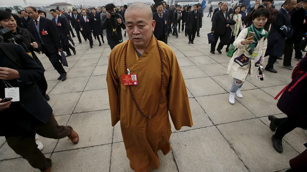 FILE PHOTO: Buddhist abbot Shi Yongxin, a delegate of the National People's Congress (NPC), walks towards the Great Hall of the People for a plenary meeting of the NPC, China's parliament, in Beijing, China, March 4, 2016. REUTERS/Jason Lee/File Photo