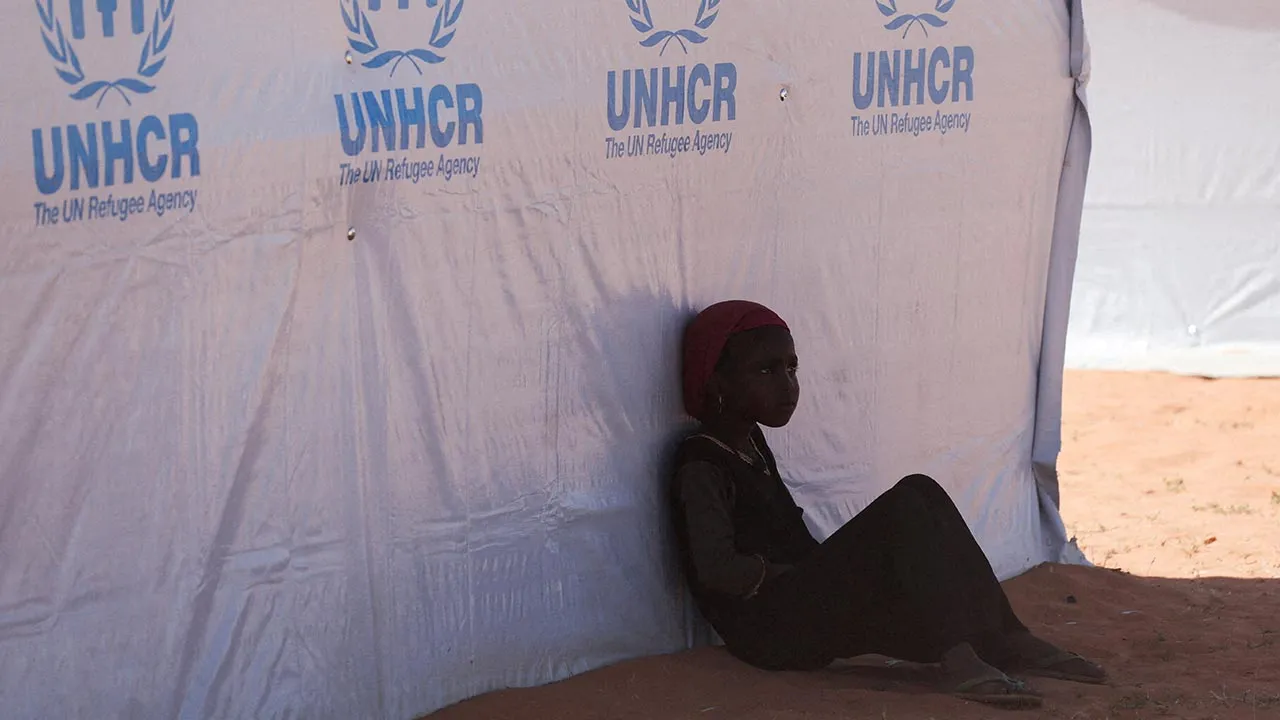 FILE PHOTO: A Sudanese refugee girl from Darfur rests beside a United Nations High Commissioner for Refugees (UNHCR) tent inside the Touloum refugee camp, amid ongoing conflict in their country, on the outskirts of the town of Iriba in Wadi Fira province, eastern Chad, November 30, 2025. REUTERS/Amr Abdallah Dalsh/File Photo