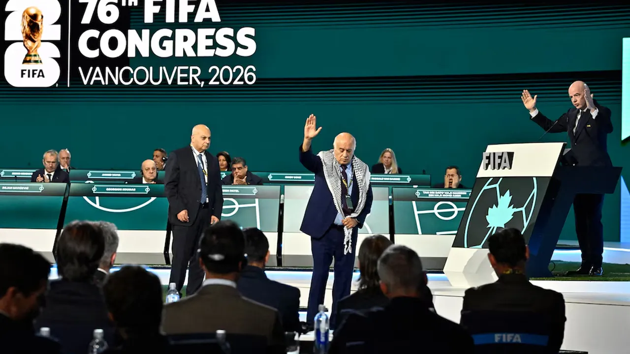 Soccer Football - 76th FIFA Congress - Vancouver Convention Centre, Vancouver, Canada - April 30, 2026 Jibril Rajoub, President of the Palestine Football association reacts on stage as Moshe Zuares, President of the Israeli football federation and FIFA President Gianni Infantino look on REUTERS/Jennifer Gauthier