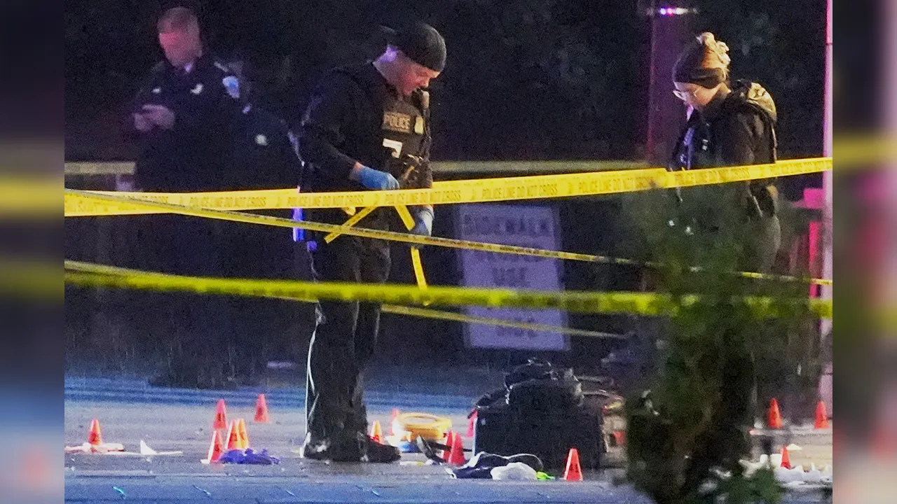 U.S. Secret Service Police examine and photograph evidence at a crime scene near the White House, Saturday, May 23, 2026, in Washington. The U.S. Secret Service shot a person near the White House on Saturday, and a bystander also was shot, a law enforcement official said. (AP Photo/Alex Brandon)