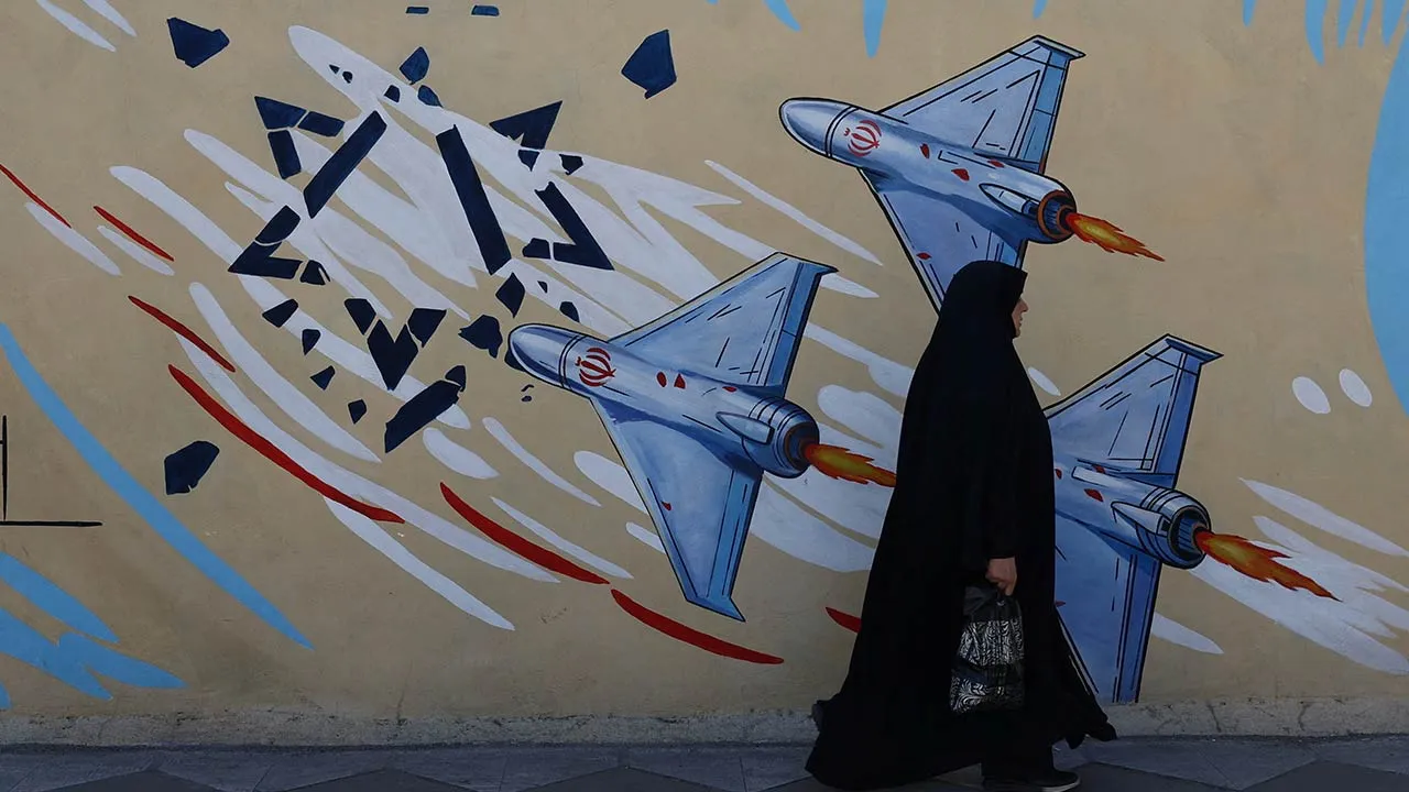 An Iranian woman walks next to an anti-Israeli mural on a street in Tehran, Iran, May 18, 2026. Majid Asgaripour/WANA (West Asia News Agency) via REUTERS ATTENTION EDITORS - THIS PICTURE WAS PROVIDED BY A THIRD PARTY