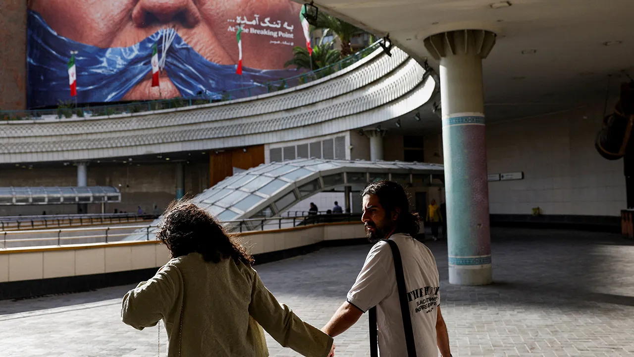 People walk past an anti-U.S. billboard depicting U.S. President Donald Trump and the Strait of Hormuz, in Tehran, Iran, May 17, 2026. Majid Asgaripour/WANA (West Asia News Agency) via REUTERS ATTENTION EDITORS - THIS PICTURE WAS PROVIDED BY A THIRD PARTY/File Photo